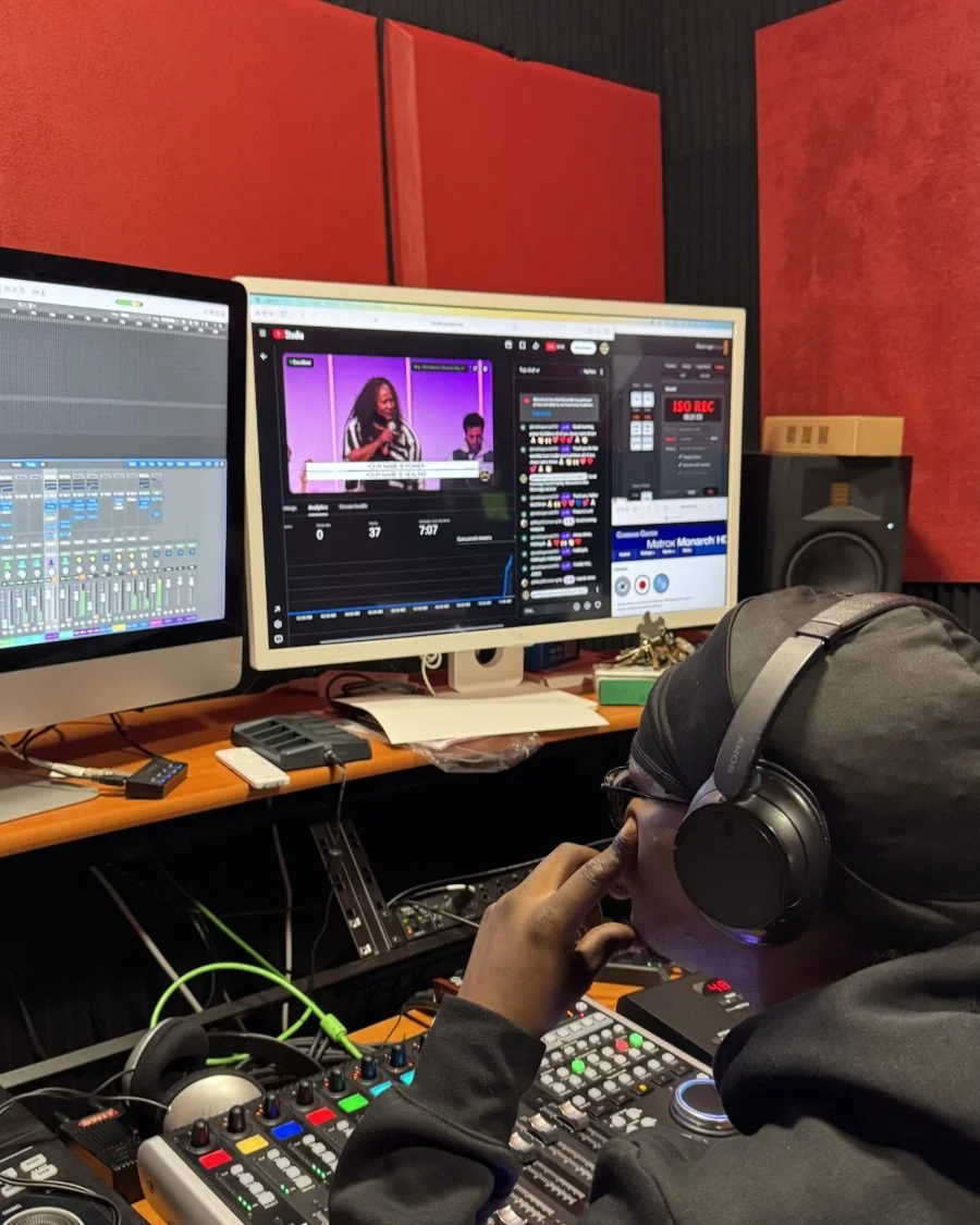 A volunteer editing video in the media studio