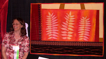 November, 2007, posing with my prize-winning quilt, "Sumac", at the International Quilt Festival in Houston, TX. Photo courtesy of Carolyn Sower.