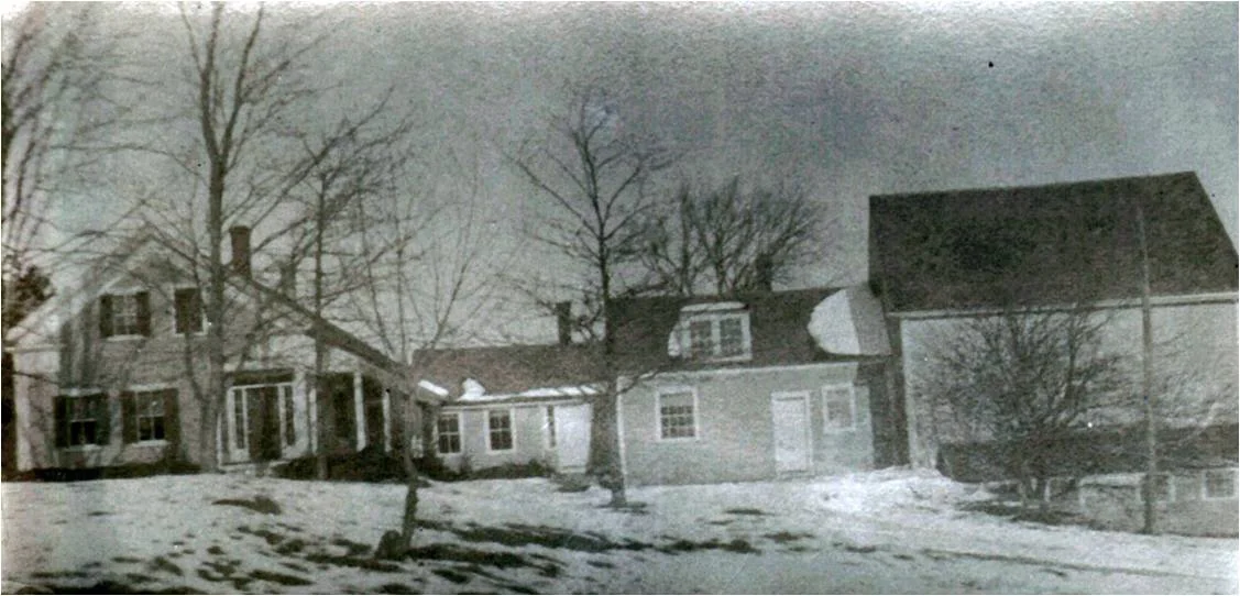 Historic images show that this Greek Revival house in East Grafton once had an earlier cape (background), ell, and barn.