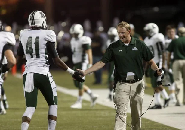 Coach John Ford acknowledging a past Hornet, now Division 1 athlete on a touchdown.