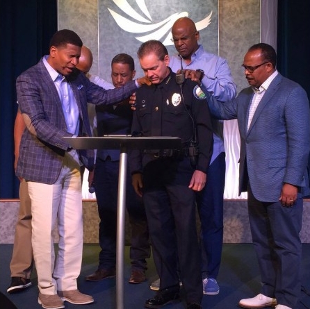 Pastor Lee Jenkins and Eagle's Nest elders praying for Police Chief Grant during the height of racial tensions this summer.