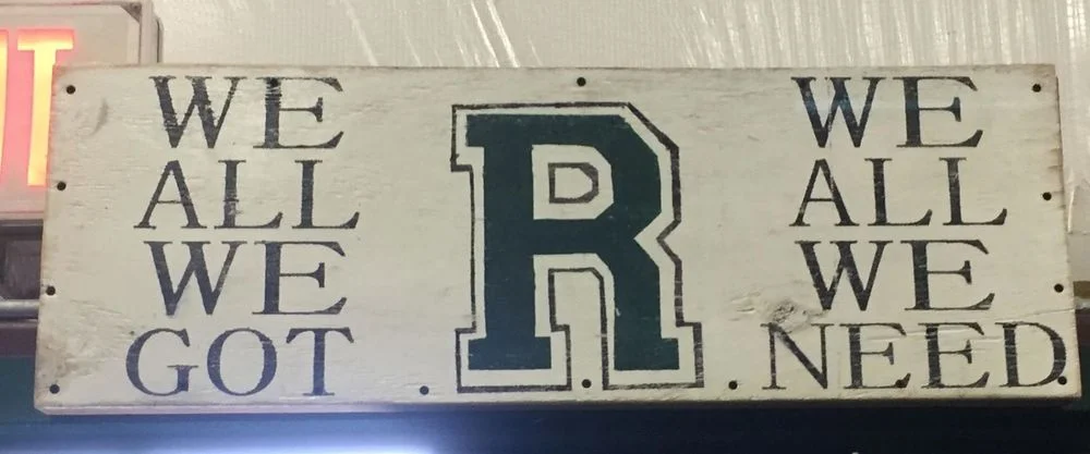 The sign that the players slap as they leave the field house for the field.