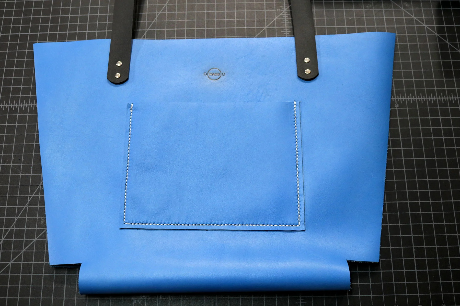 Completed saddle stitching for leather tote bag pockets