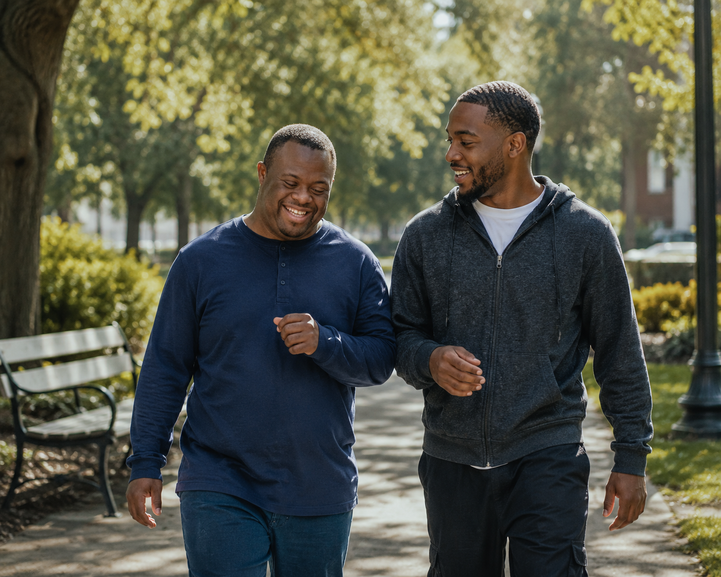 Two men walking together in a park, smiling and engaging in conversation.