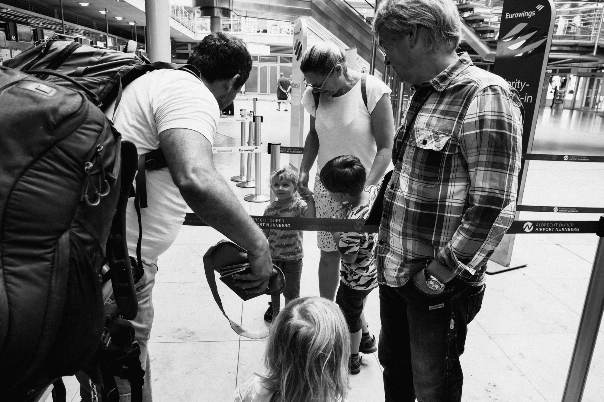 Friends and kids come to say goodbye to travelers at the airport.