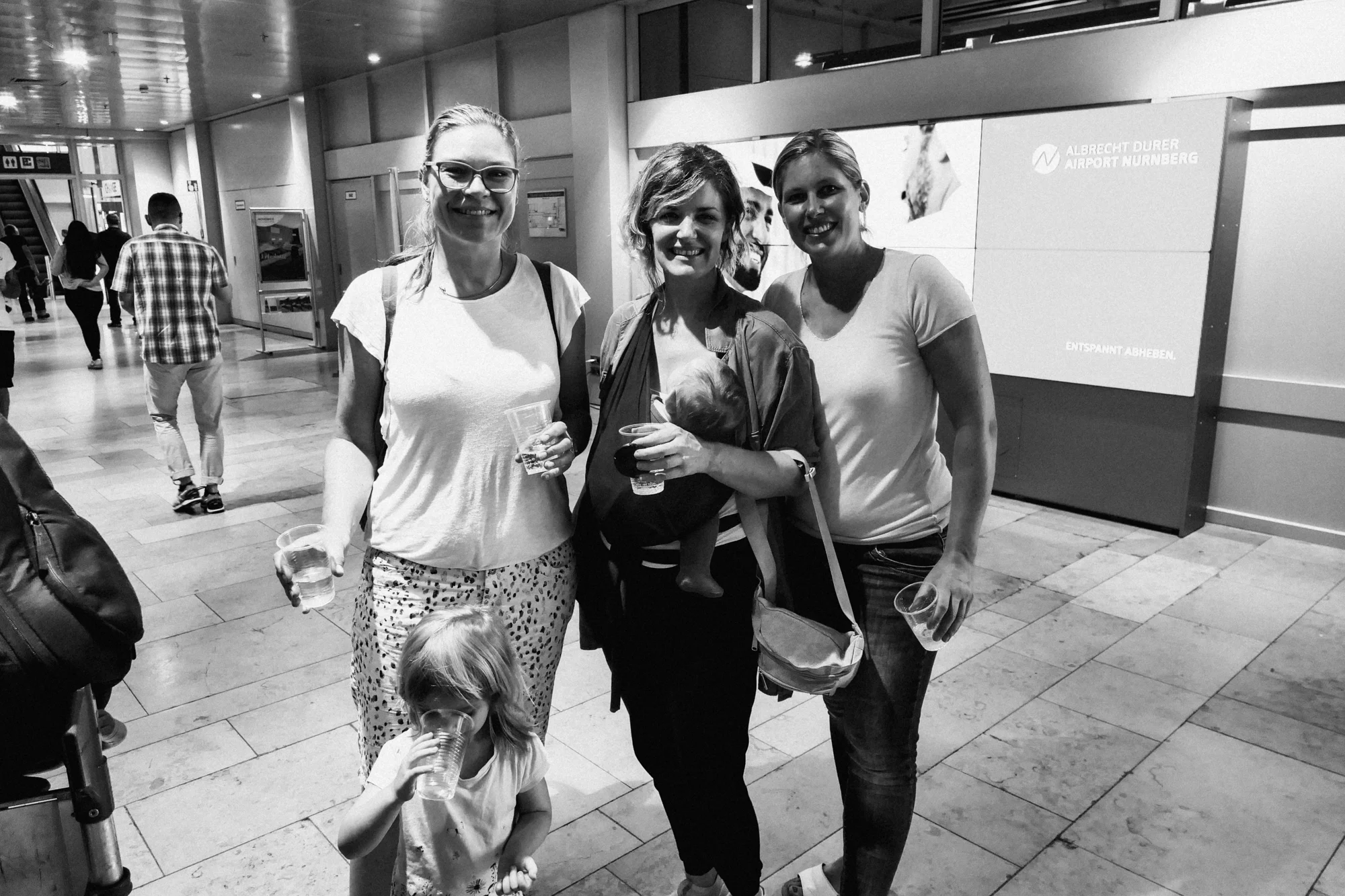 Women friends saying goodbye at airport.