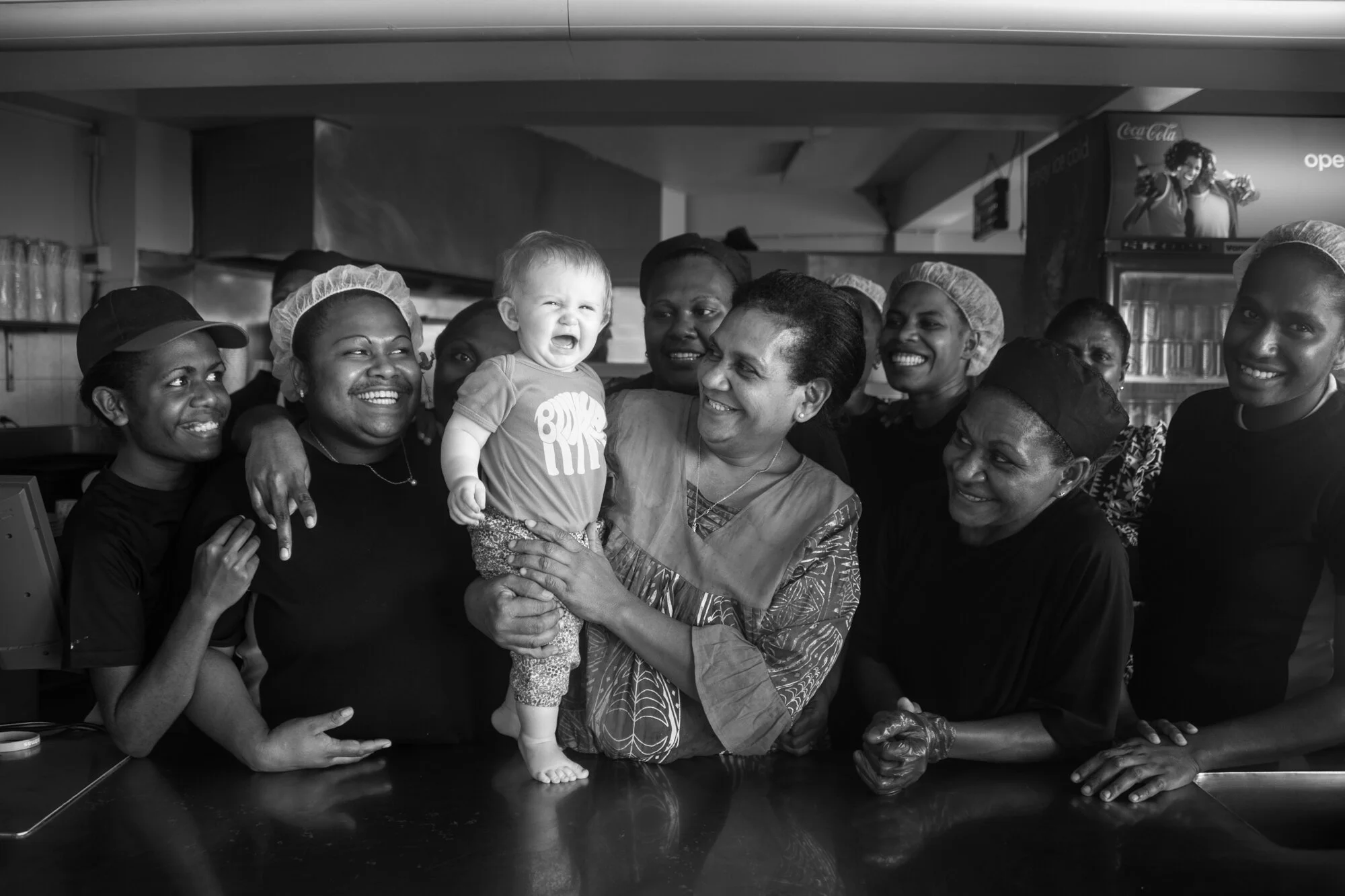 White baby in a group of locals, Port Vila, Efate, Vanuatu