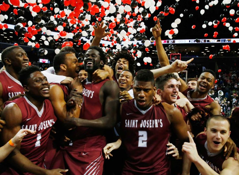 Papi Ndao celebrates with St. Joe's teammates after beating VCU in the A-10 Championship