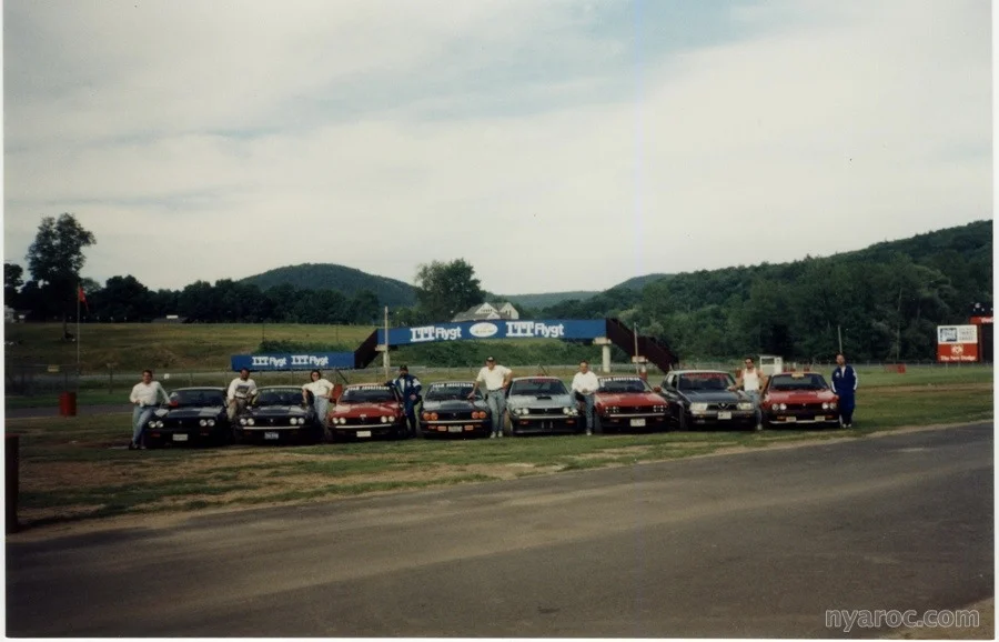 Team Shoestring (a/k/a The Alfa Boys, GTV6 Chapter) group photo in the paddock at Lime Rock