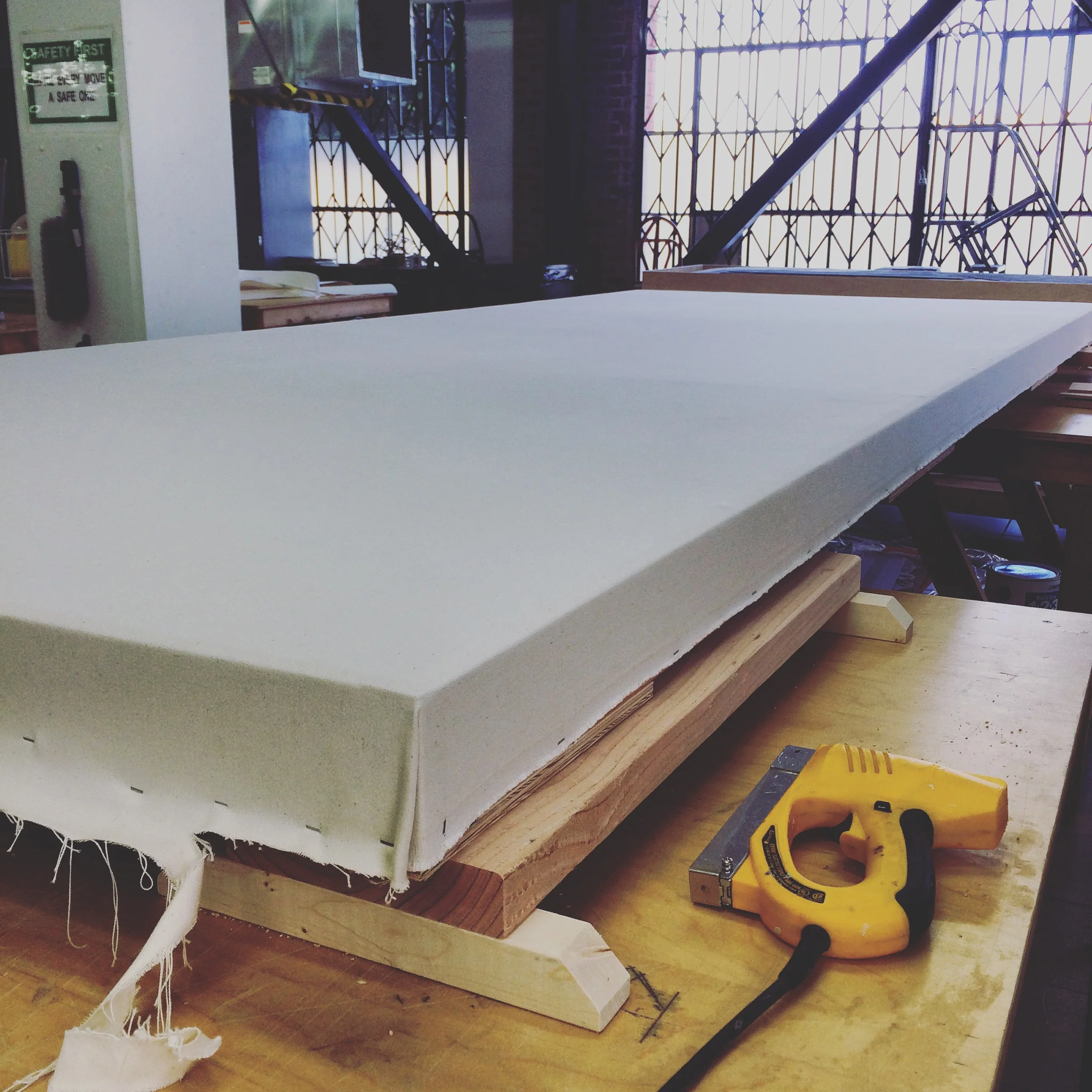  Our focal point, a 12'x5'&nbsp;canvas was framed with 2x4s. The canvas material was then stretched over the 1/8" luan used to support the face, then stretched and stapled into place. 
