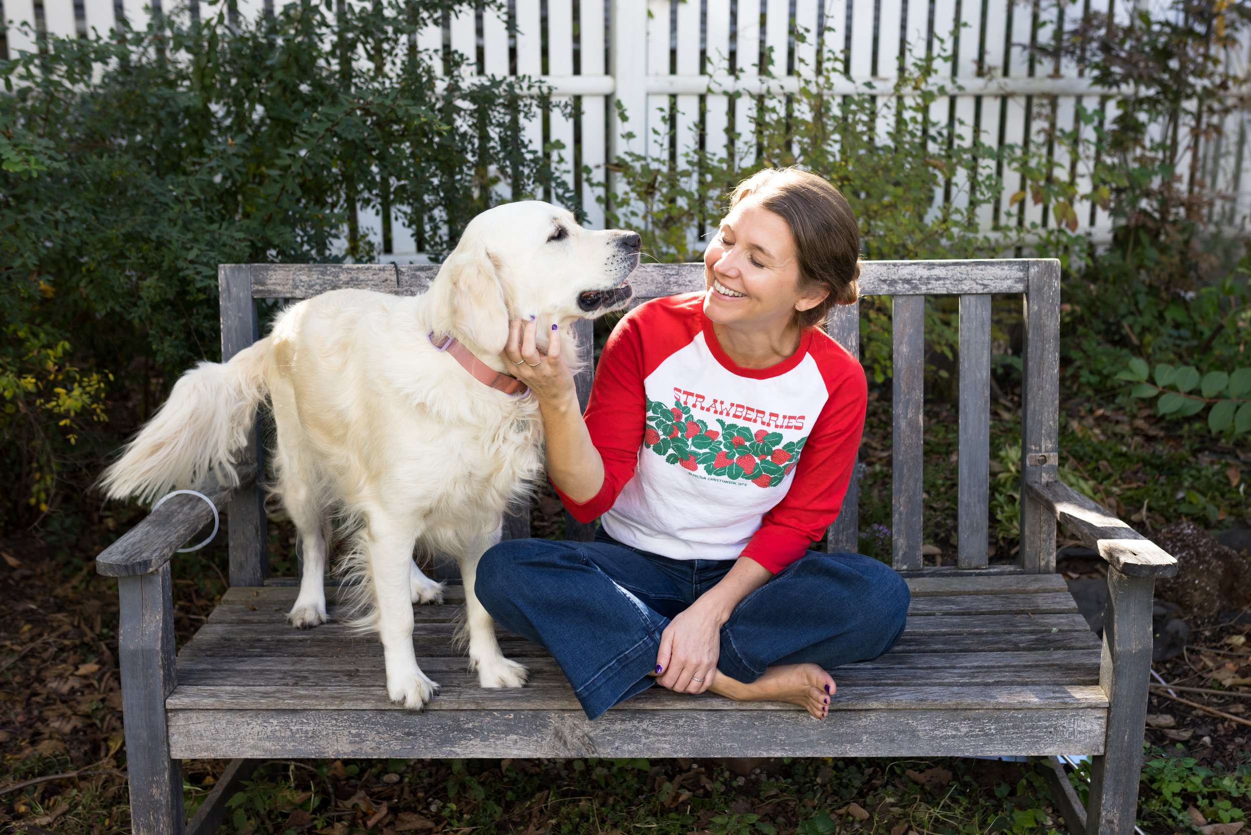 artist and designer Jenny Rutherford at home in her back yard with Nellie, the buttercream golden retriever.