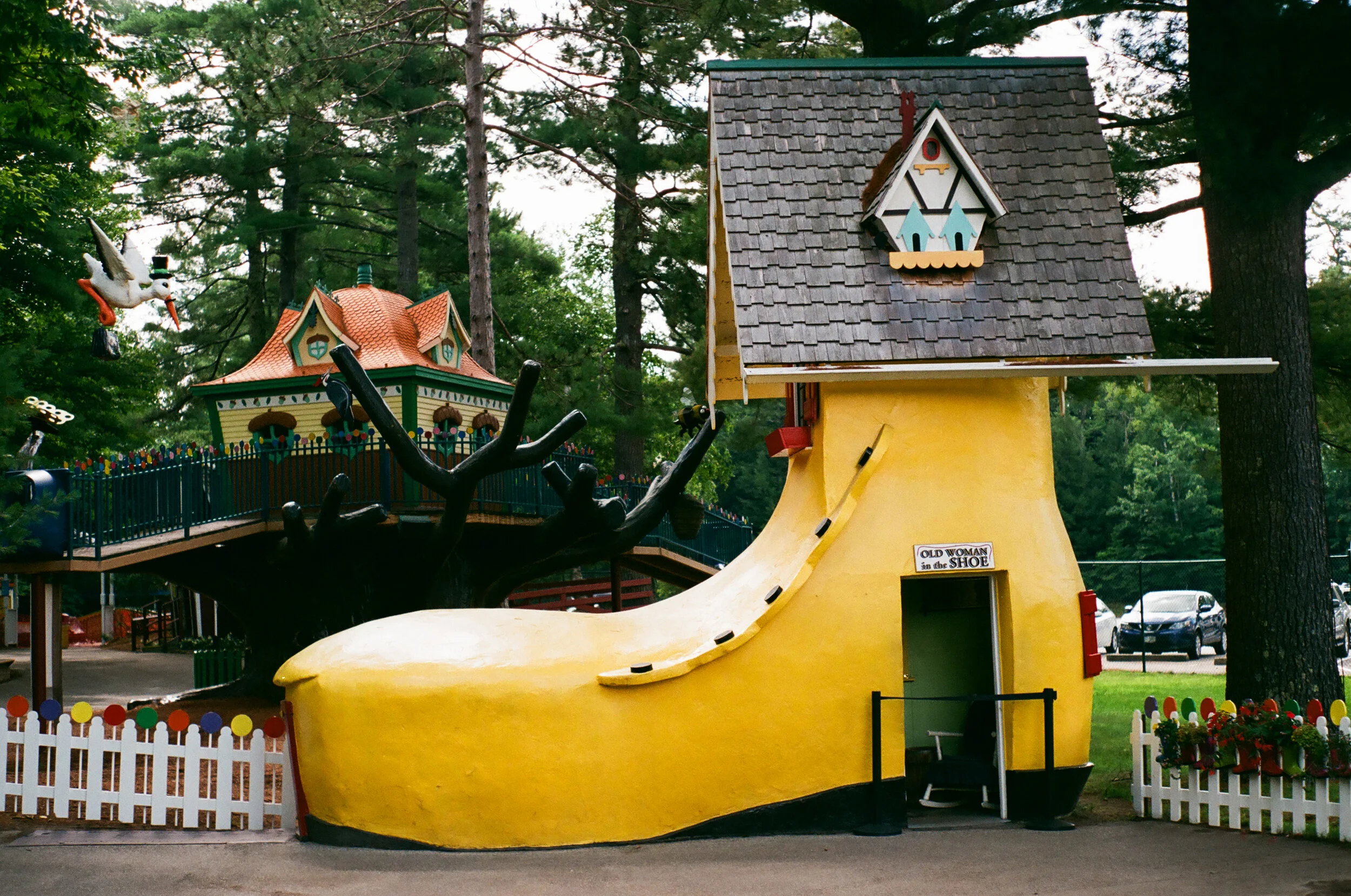 The old Woman who lived in a shoe feature at Storyland, in Glen, New Hampshire. It is a bright yellow giant boot with a little roof.
