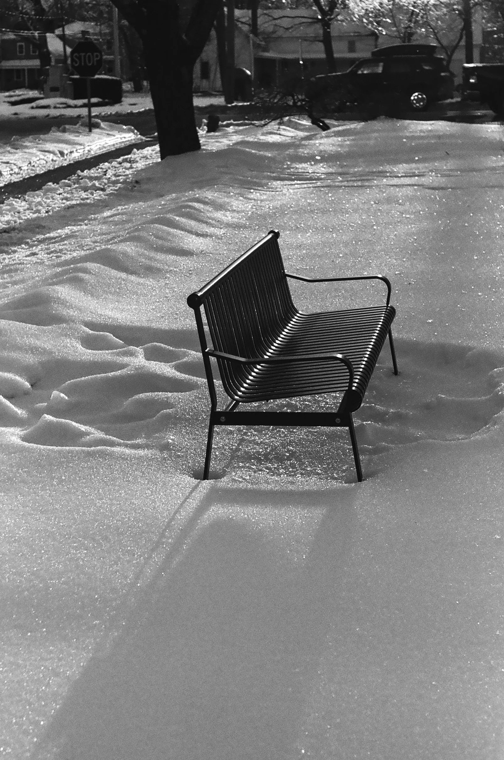 an image of a park bench in the snow.