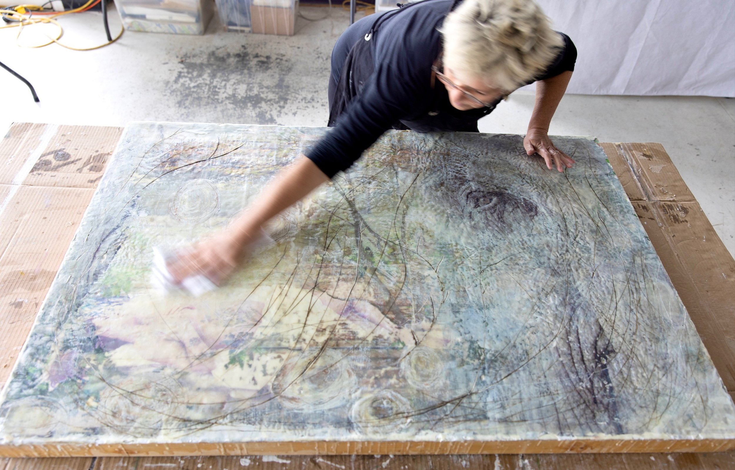Heidi buffing a large painting.jpg