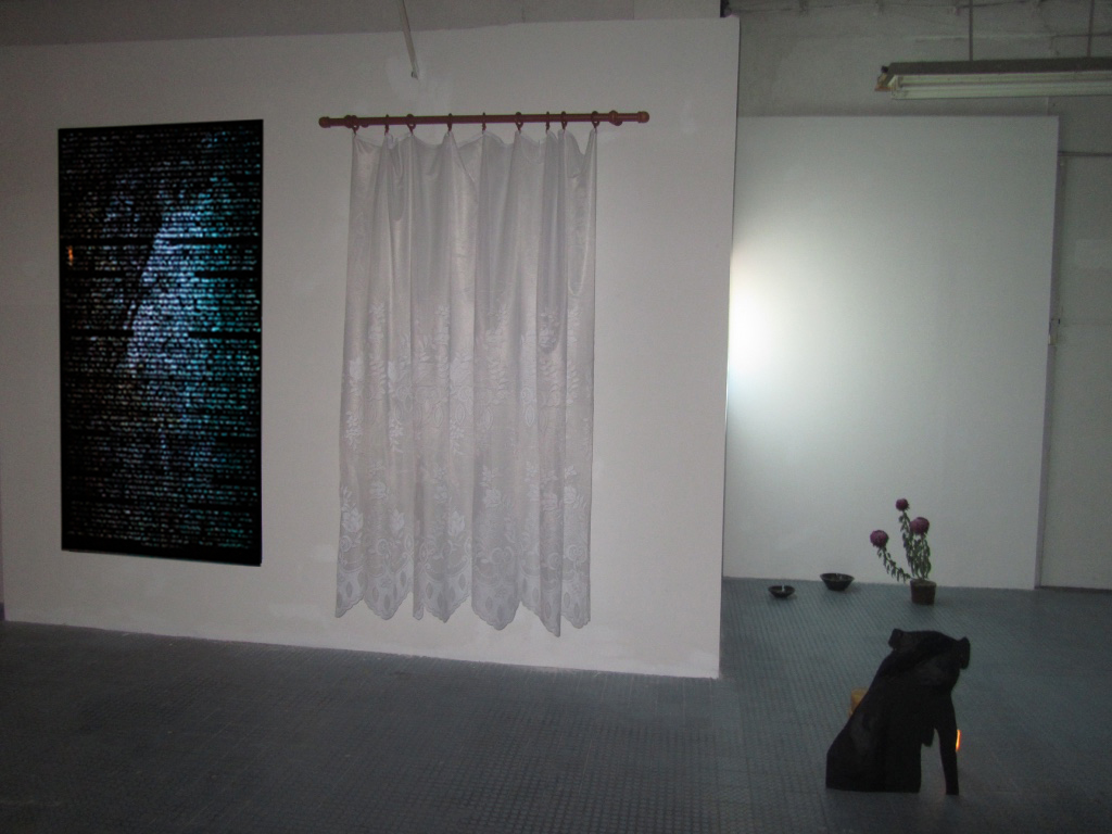 The Light and the Heavy , 2016, Installation view at D'Clinic Studios, Zalaegerszeg, Hungary 1. The boar who became a deer interactive mapping video on digital print. 2. Resistance lace curtain and curtain rod 3. (Front) He had been given a name and it was clear that he knew something wood, paper, paint, bricks, candle 4. (Back) Untitled cermic bowls made at Gébárti Kézművesek Háza during the Saturday morning pottery workshop, Chrysanthemum ‘Regal Mist Purple’ bought at the Zalaegerszeg farmers market on the 30th of October 2016