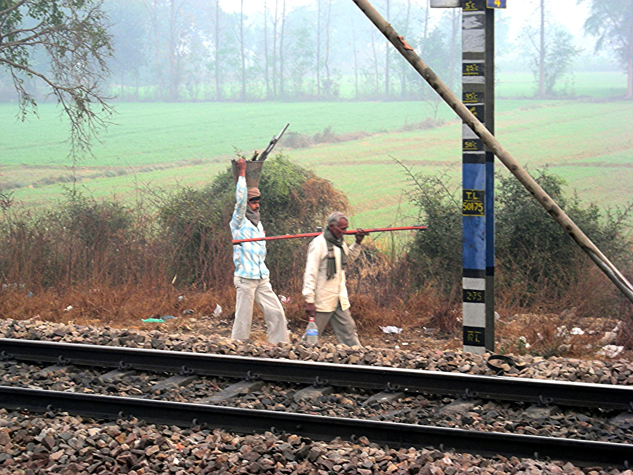 Walking to work along the railway tracks, seen from train window