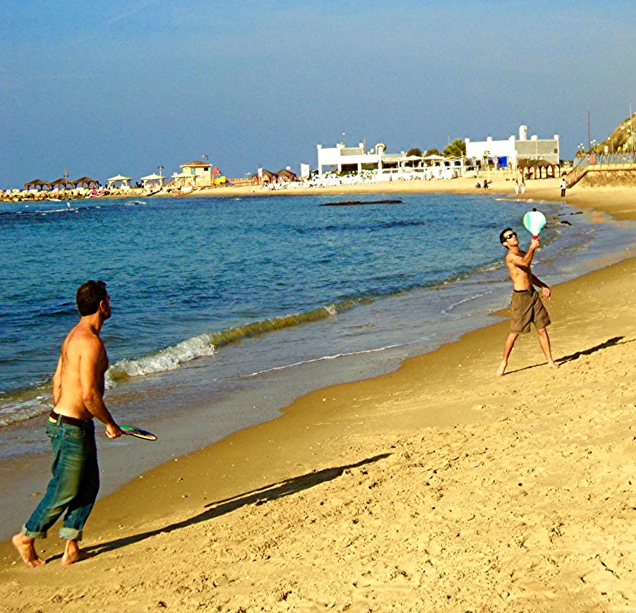 Playing matkot on the Hilton Beach