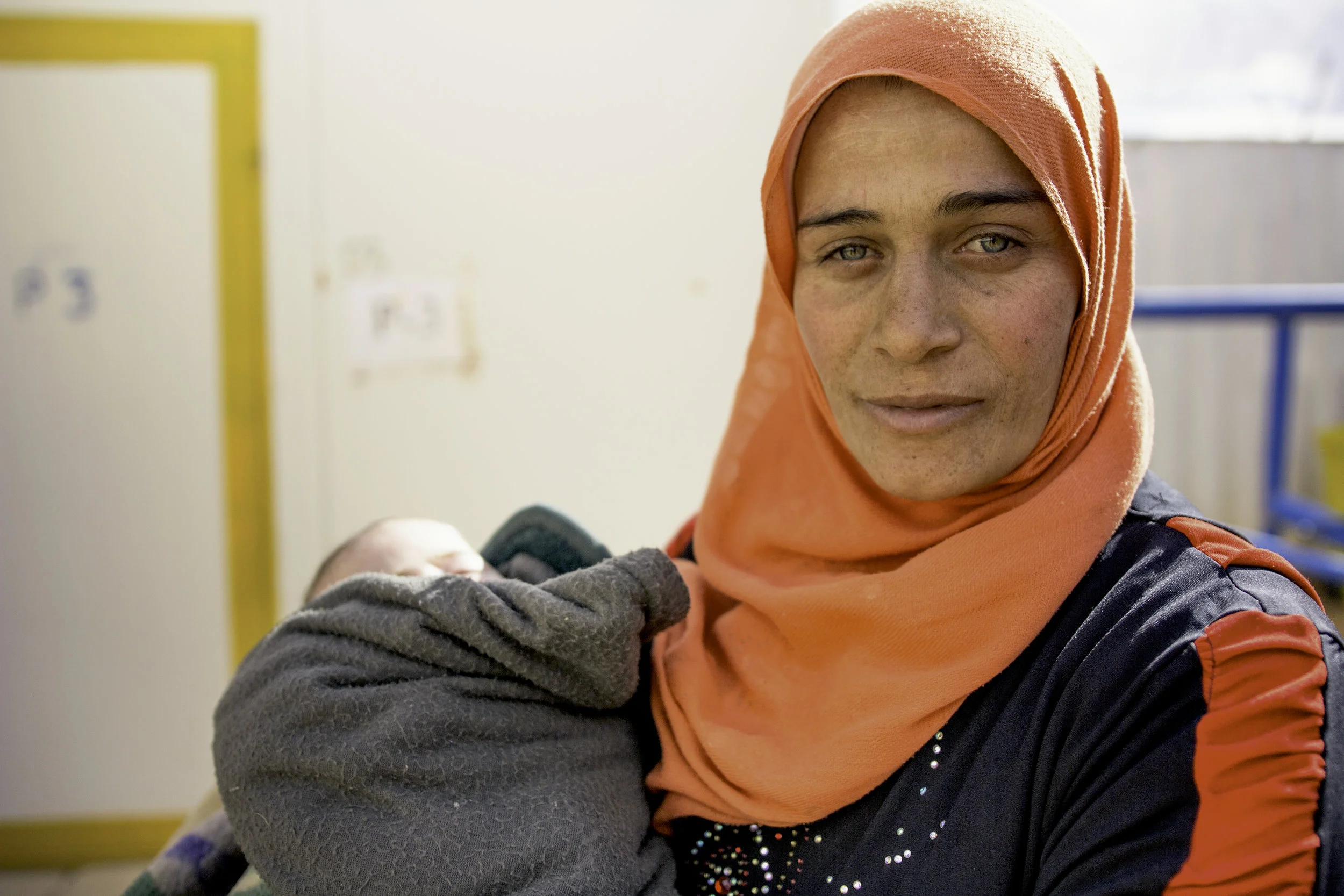 Syrian woman and baby at a UNFPA-supported reproductive health clinic at "the berm," where 50,000 Syrians are stranded in no-man's land