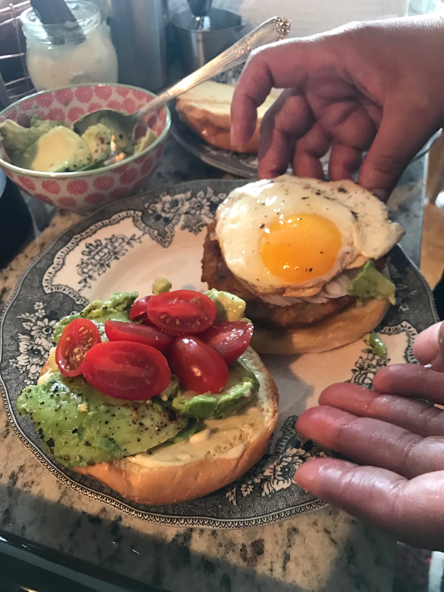 Veggie burger with avocado, cherry tomatoes, basil aioli, and an over easy egg. 