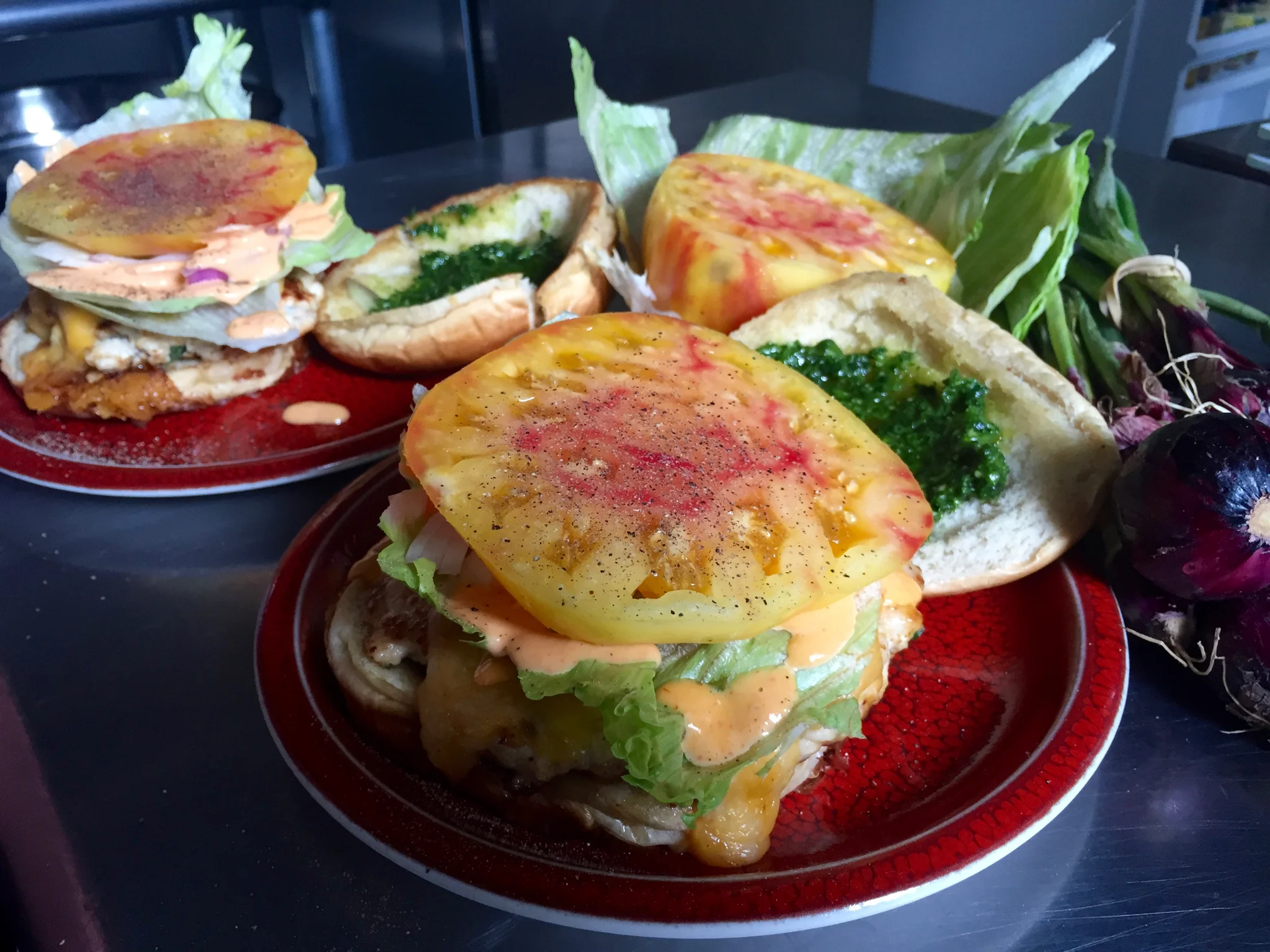 Turkey burger with spinach pesto, lettuce, heirloom tomato, and Sriracha mayo. Charlene is obsessed with fresh heirloom tomatoes in summertime and loves to get a variety of colors and sizes from the farmer's market!