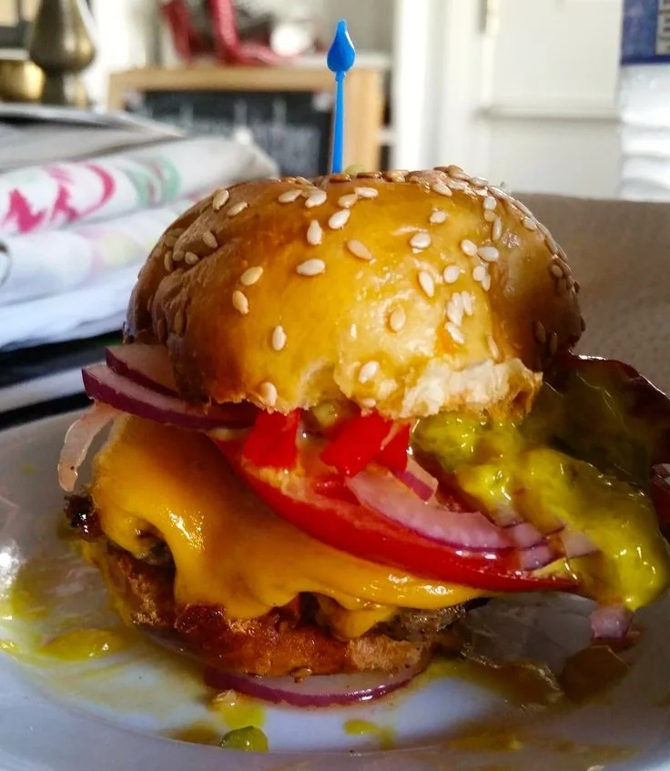Mini turkey burger with Pennsylvania relish, onion, tomato, and cheddar cheese.