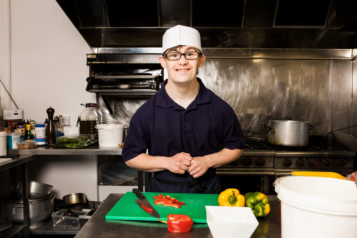 Young person working in the kitchen at Foxes Hotel