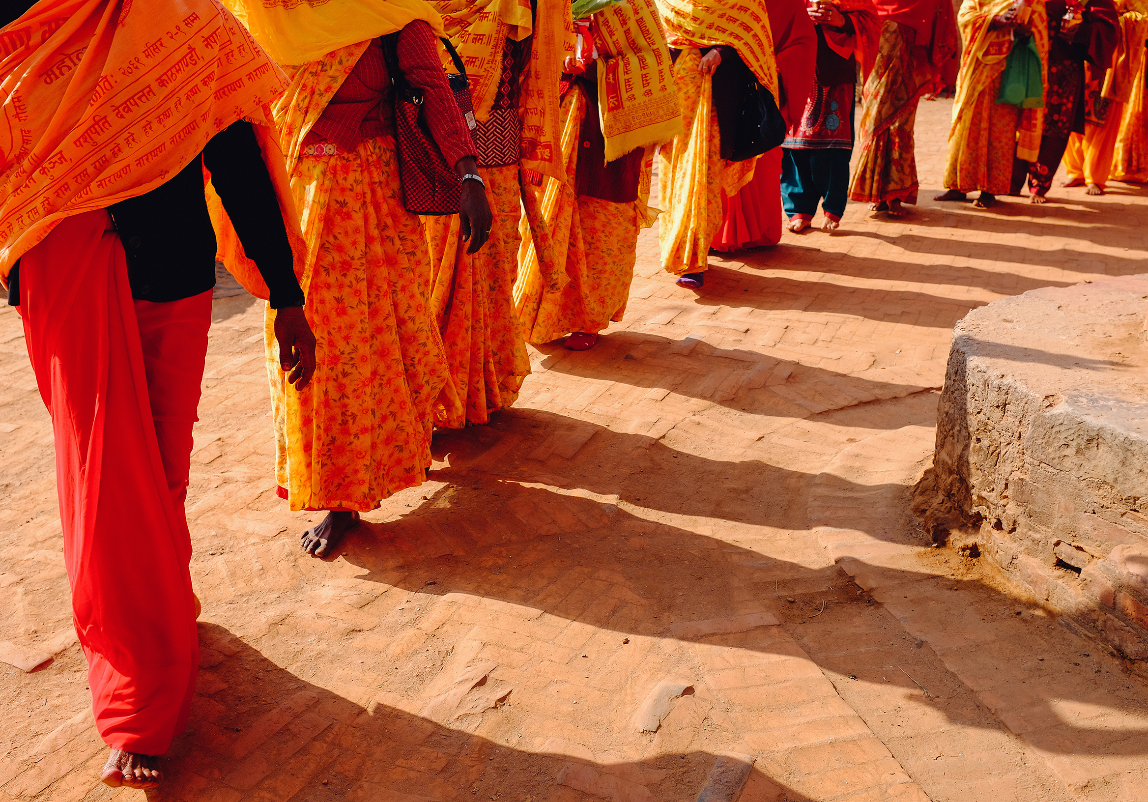 BHAKTAPUR, NEPAL — Women in the village walk barefoot during a procession for a deceased leader.