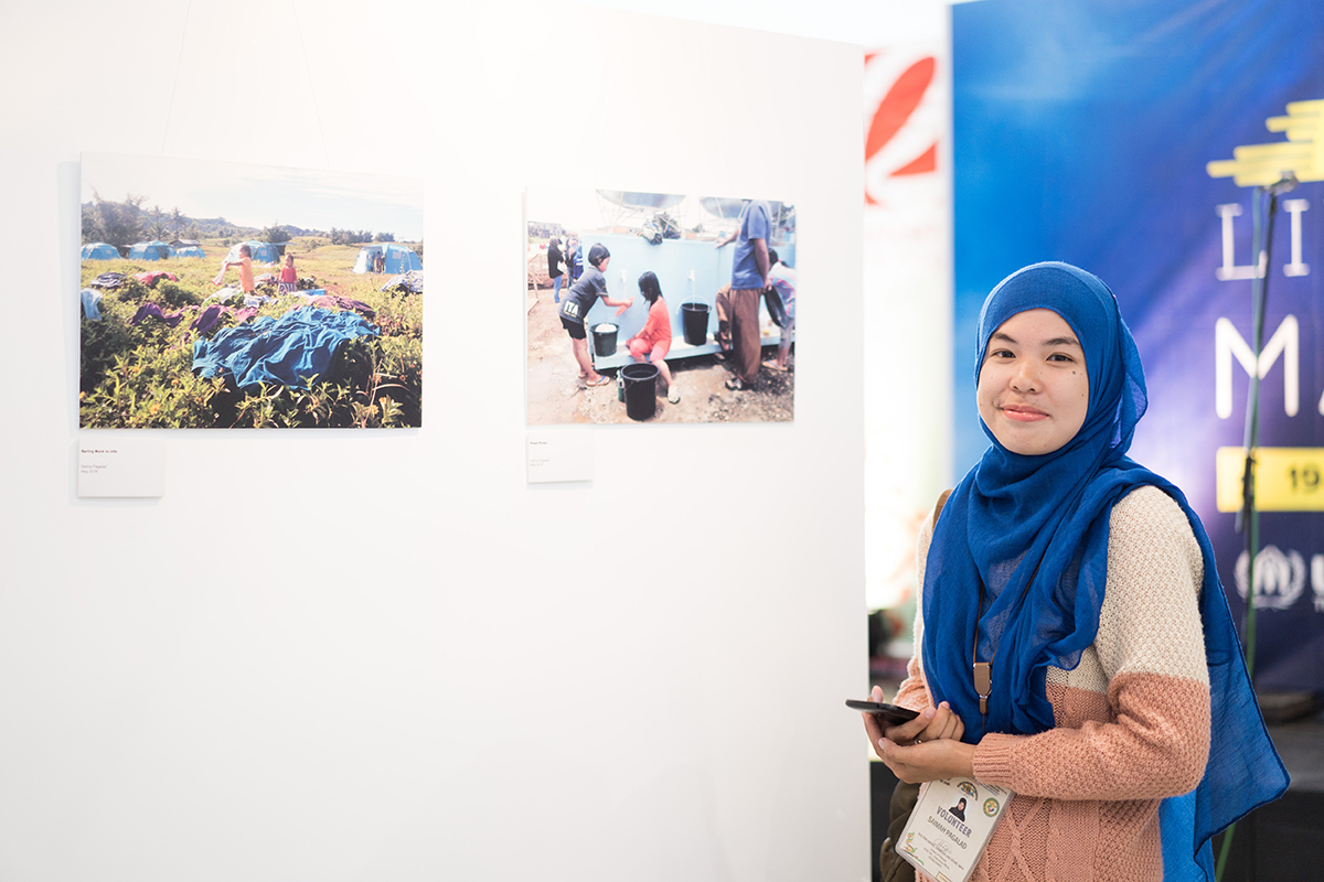 Saima Pagalad is among those who were displaced by the Marawi conflict. Some of the photos she took to document the forced displacement were featured in the exhibit. (Photo ©UNHCR/Martin San Diego)