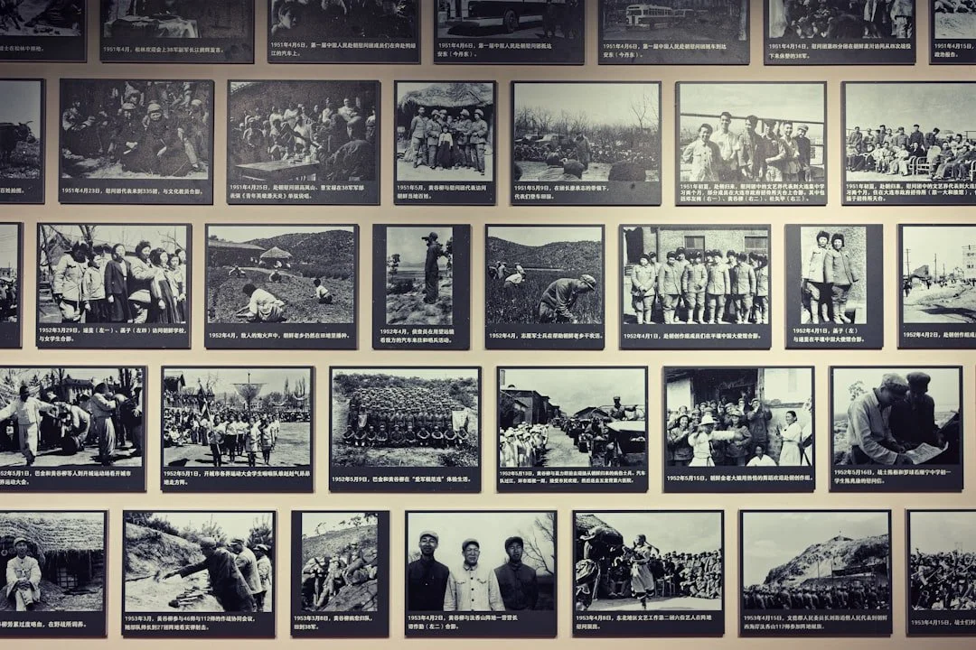 A wall with black and white historical photographs of people, events, and activities, each with Chinese captions.