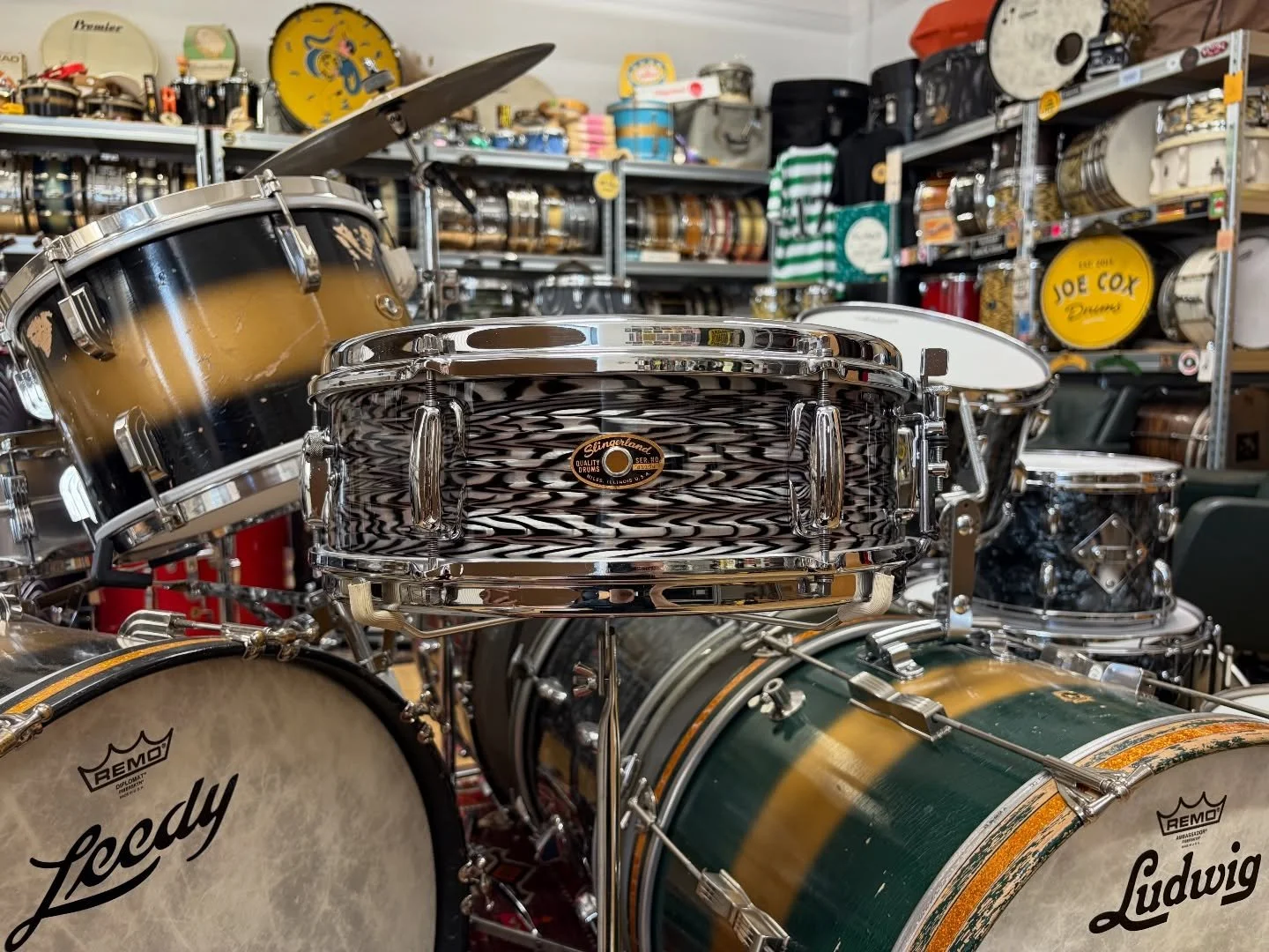 May 1965 Slingerland &lsquo;Deluxe Student Model&rsquo; 14x5&rdquo; in original Grey Agate Pearl.

3-ply shell, 6 lug design, chrome over brass &lsquo;Rim Shot&rsquo; hoops, &lsquo;Rapid&rsquo; strainer, and internal tone control. Fresh out the works