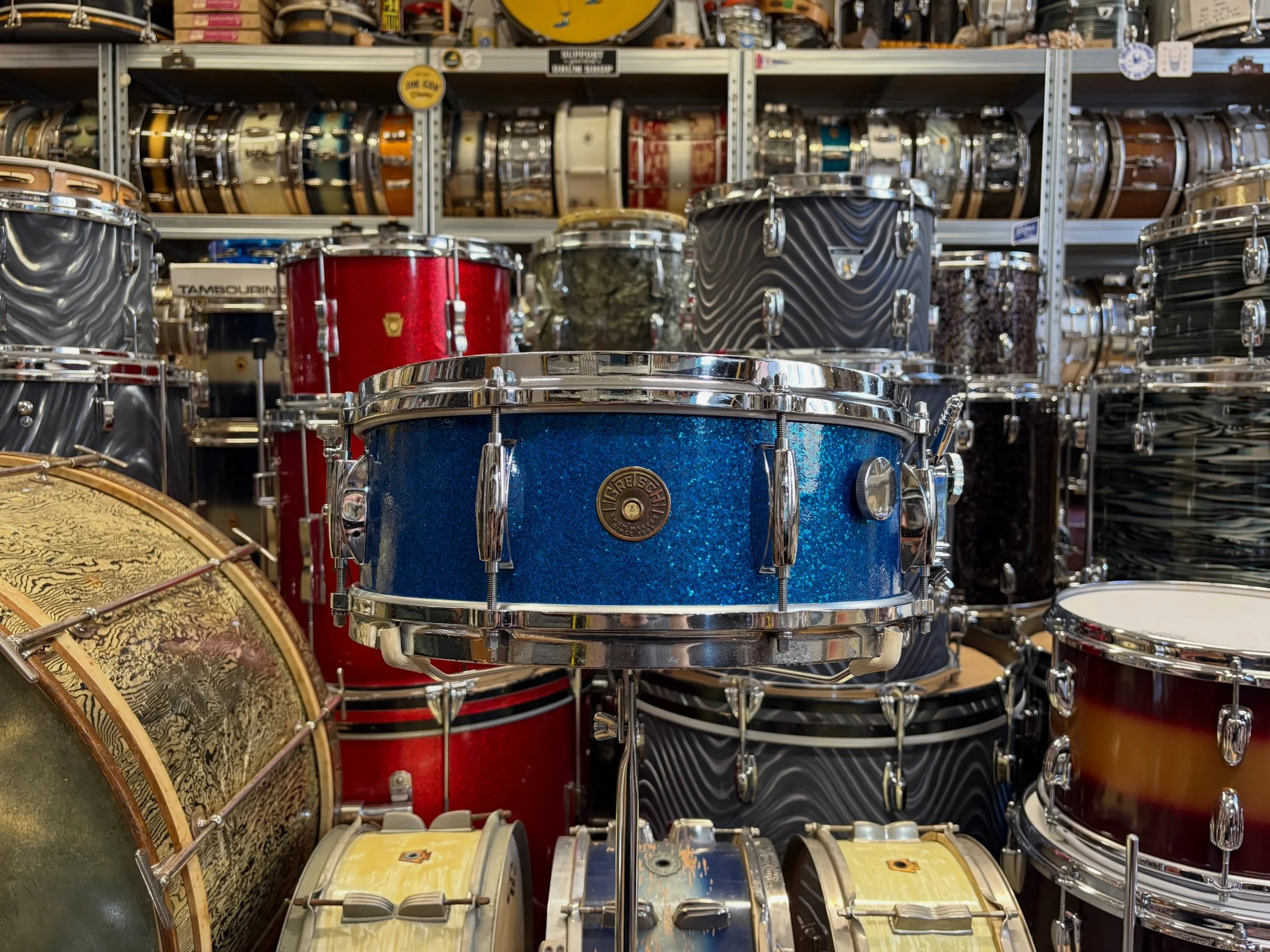 1960s Gretsch Round Badge &lsquo;Name Band&rsquo; No. 4157 Model snare drum sized 14x5.5&rdquo; in original Blue Sparkle Pearl.

6-ply shell with silver sealer interior and original paper tag. 

Original chrome hardware including die cast hoops, inte