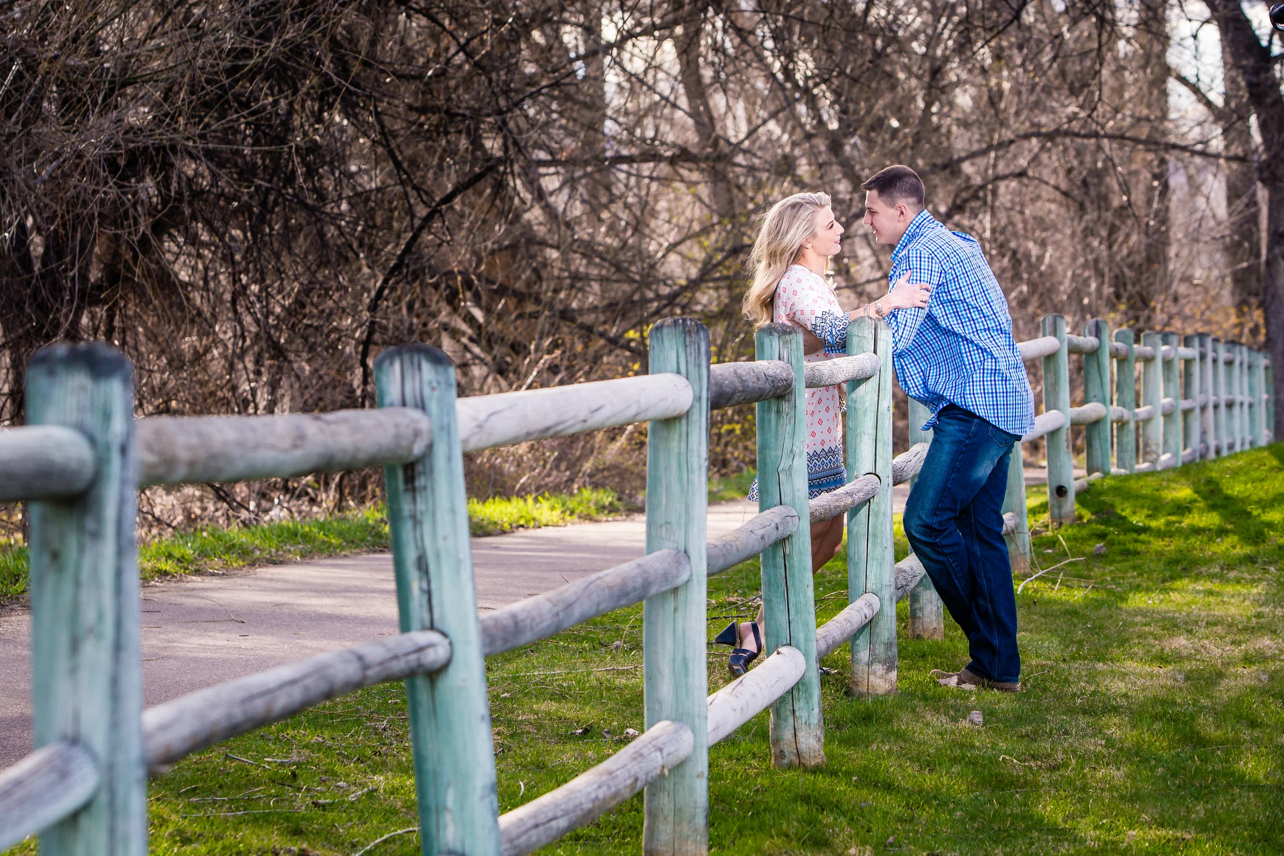 Engagement picture along wood fence. Taken in Fort Collins Colorado by Jared M. Gant