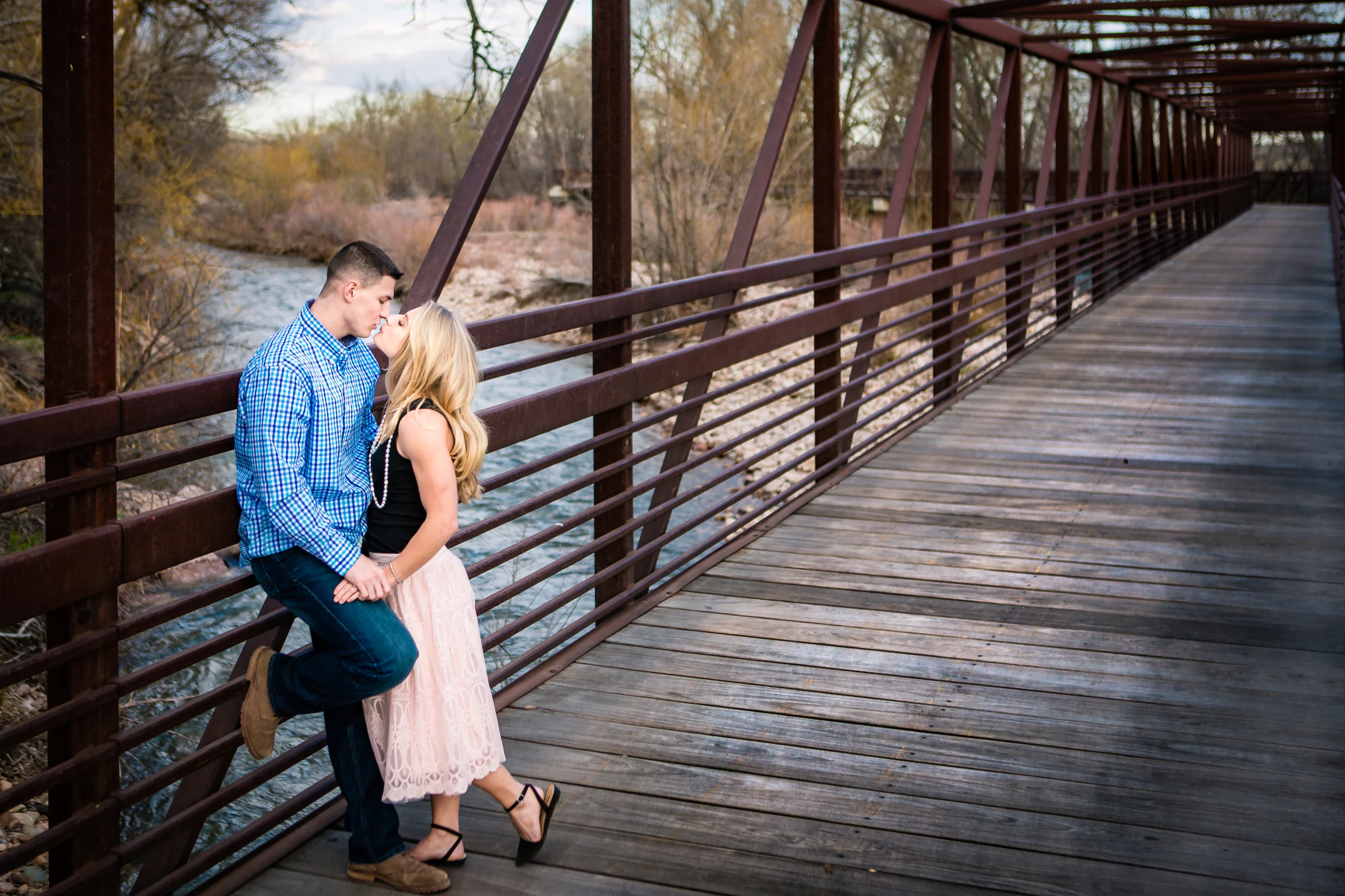 Engagement pictures taken on Lion Park bridge in Fort Collins Colorado by JMGant Photography