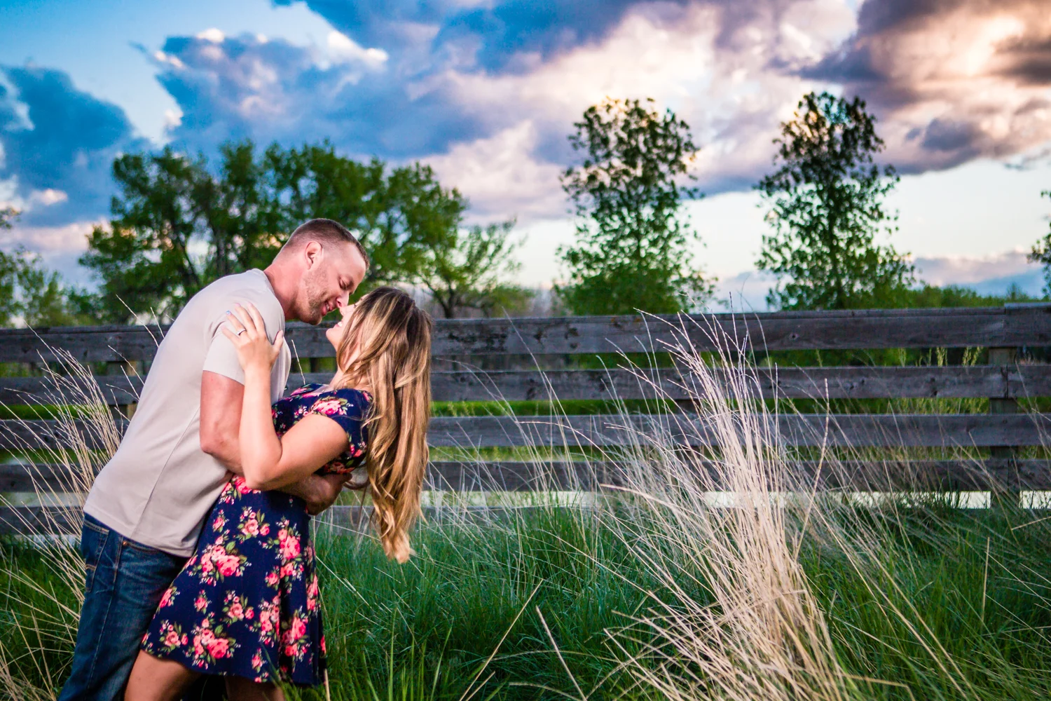 Engagement with a rustic fence at Sandstone Ranch. Take by Jared M. Gant