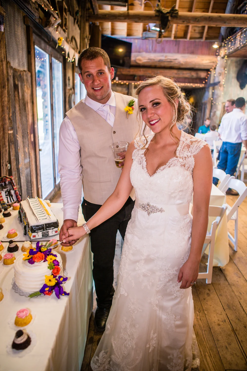 Cutting the cake. Wedding at The barn at Evergreen Memorial. Photographed by JMGant Photography.