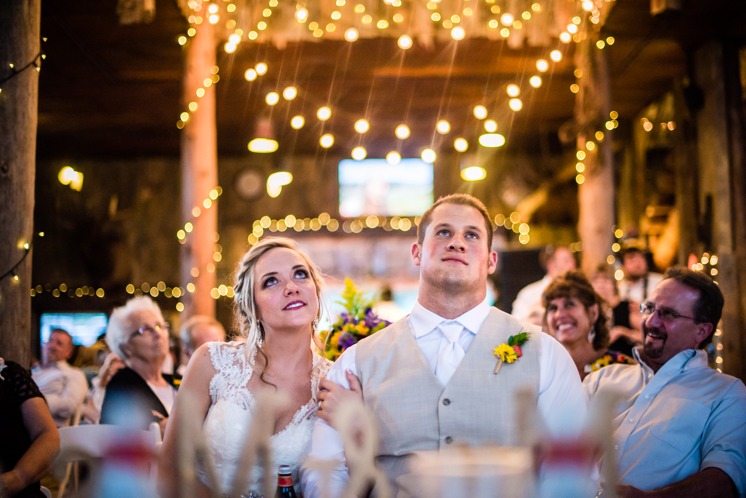 Watching their wedding video. Wedding at The barn at Evergreen Memorial. Photographed by JMGant Photography.