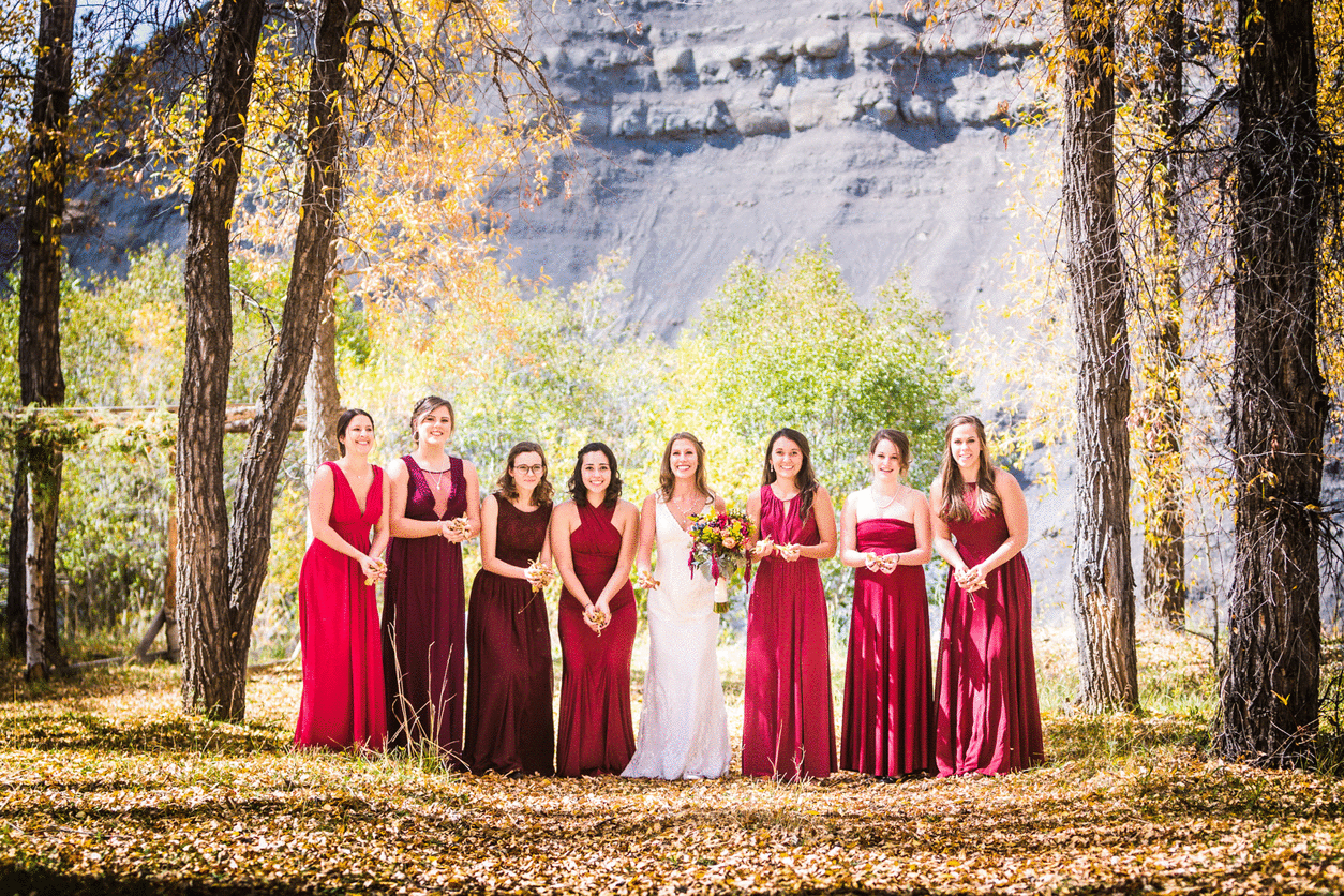 Bridesmaids throwing leafes by JMGant Photography.