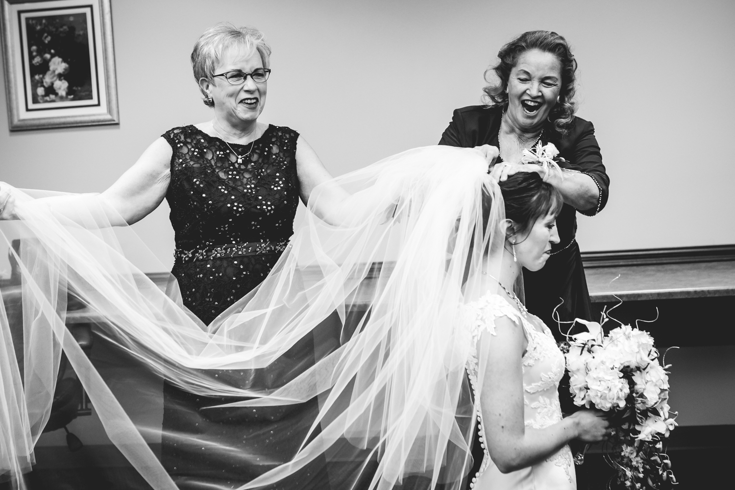 Mothers helping the bride get her vail on by JMGant Photography.
