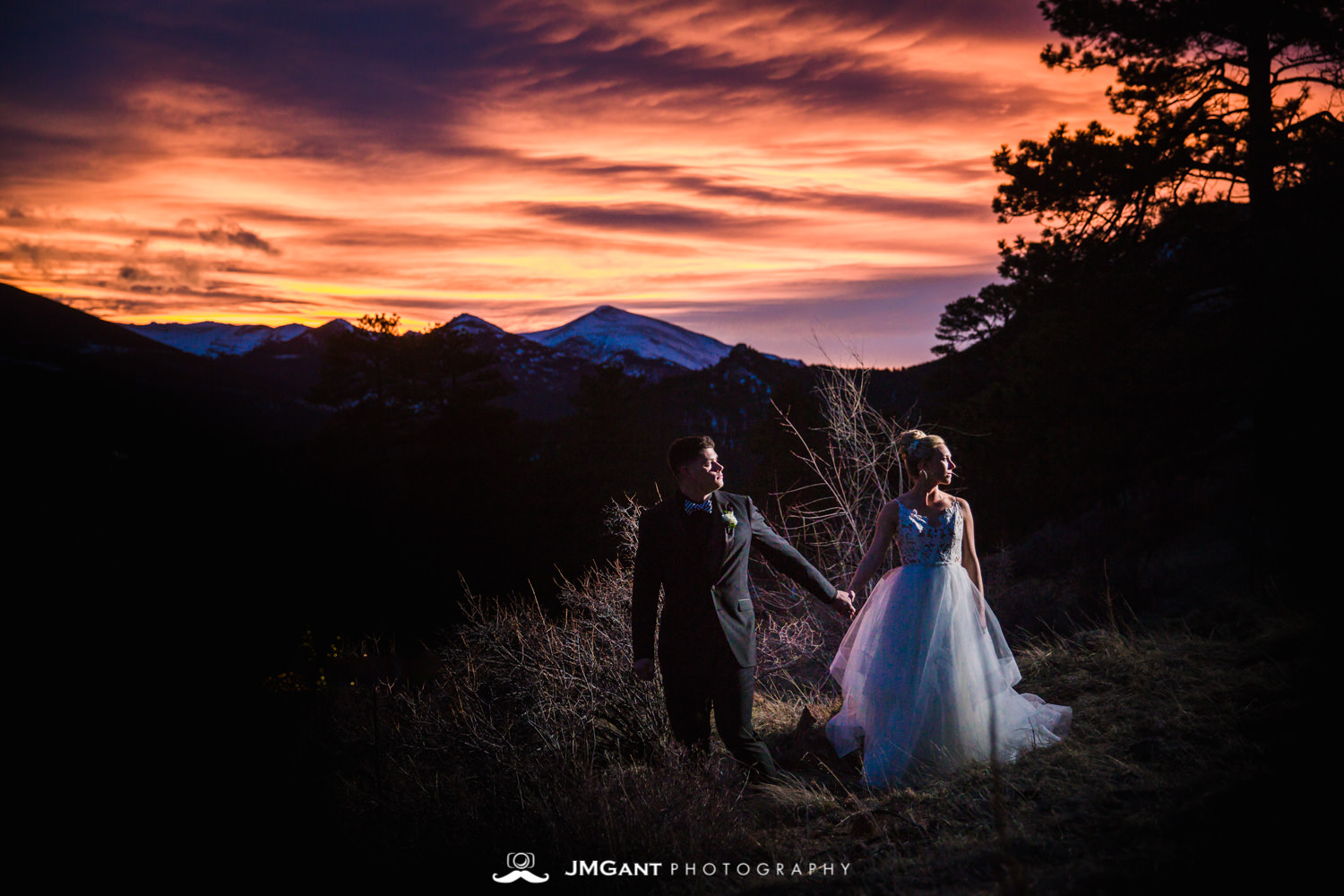 Colorful rocky mountian wedding sunset at the Della Terra Mountain Chateau in Estes Park Colorado. Photographed by Jared M. Gant of JMGant Photography.
