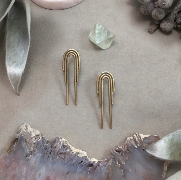 Drop Arch Studs- feature delicate arch designs cast in bronze.