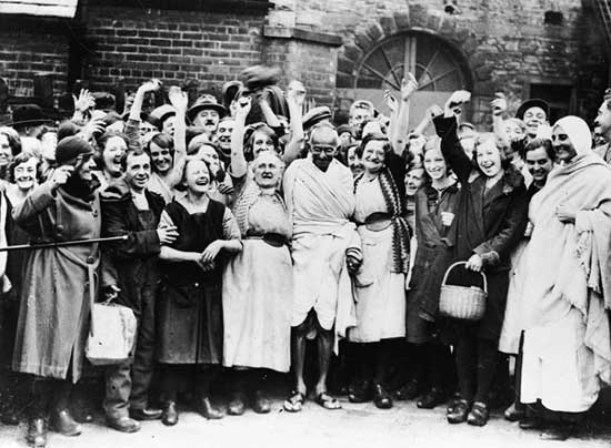 Gandhi has a laugh with millworkers in Darwen, Lancashire.