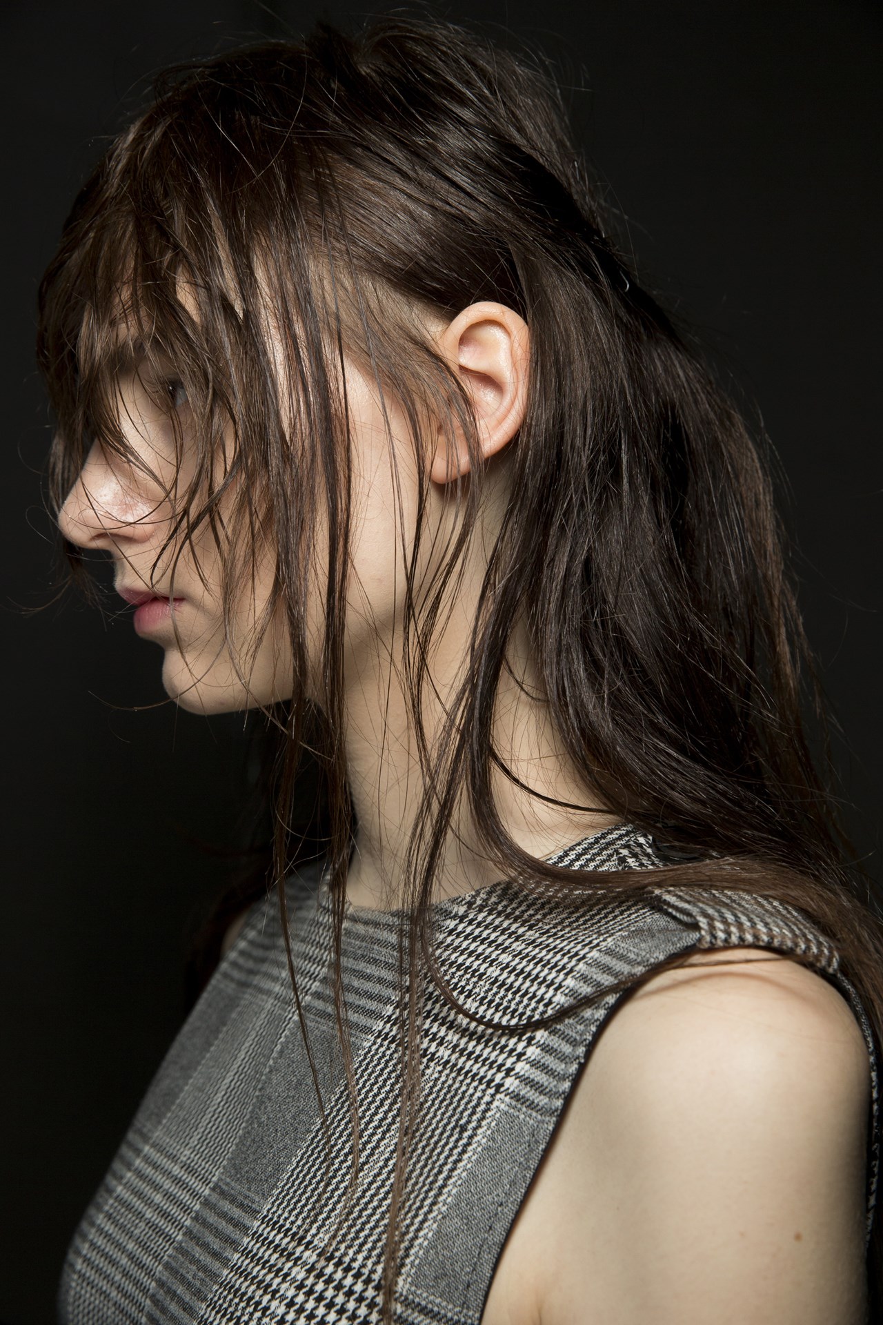 Christopher KaneHair, by Guido Palau, was styled in messy loose styles, pinned at the nape of the neck and with strands hanging over the eyes. Some models also wore plastic rain hats by Stephen Jones over the hair.