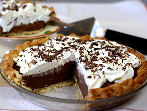 Chocolate Cream Pie made with Basic Pie Crust , filled with Chocolate Pastry Cream, garnished with Whipped Cream That Won't Fall Flat , and topped with shaved milk chocolate.