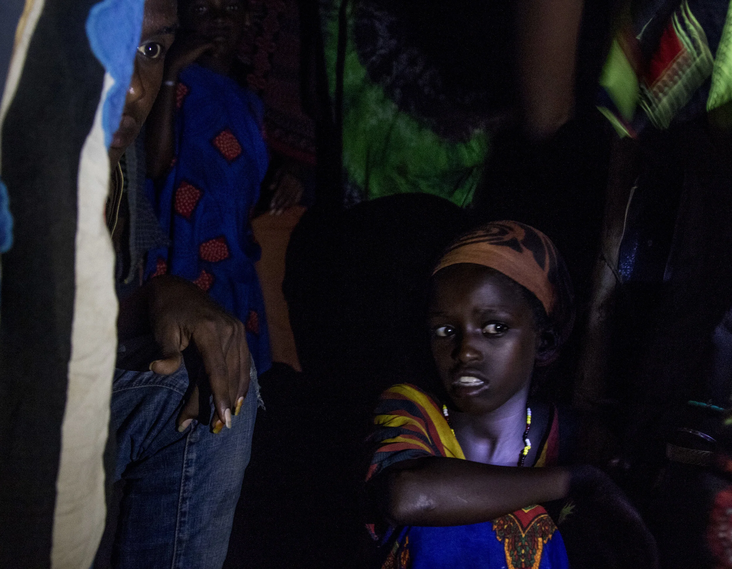 April 1, 2018, Dambala Fachana, Kenya- Two refugees peer inside the shelter at night.