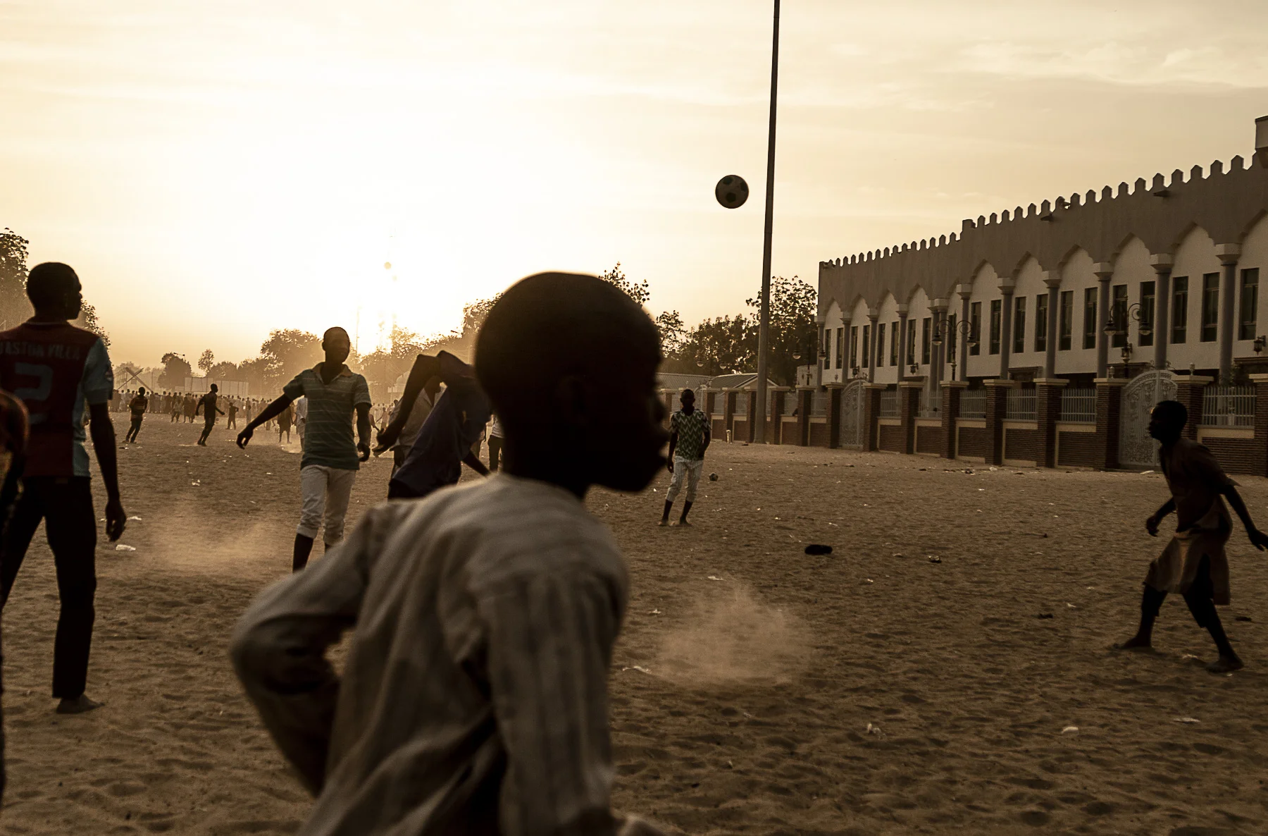 February 22, 2019, Maiduguri, Nigeria- Kids play football outside a mosque the day before elections will commence.