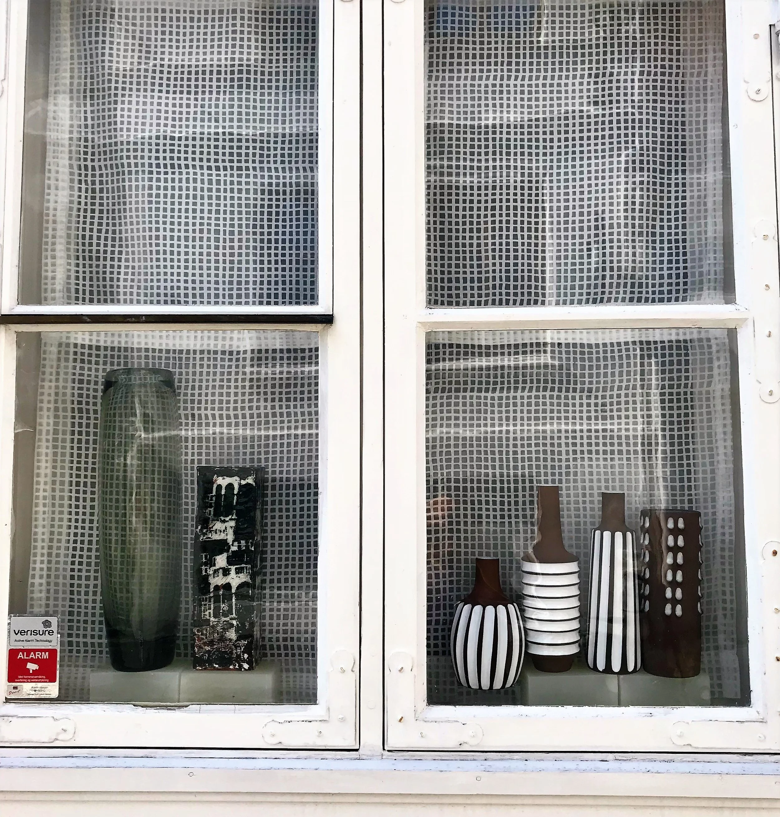 Someones ceramic collection in their front window In Bergen.