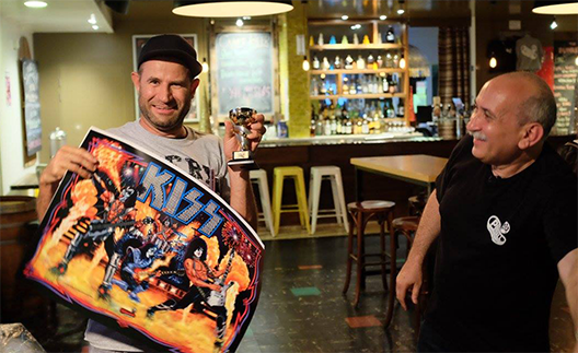 A giant of a man, Paul makes this trophy look tiny. Photo by the Australian Pinball League.