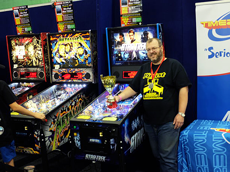 Rob adding yet another trophy to the collection. Photo by the Australian Pinball League.