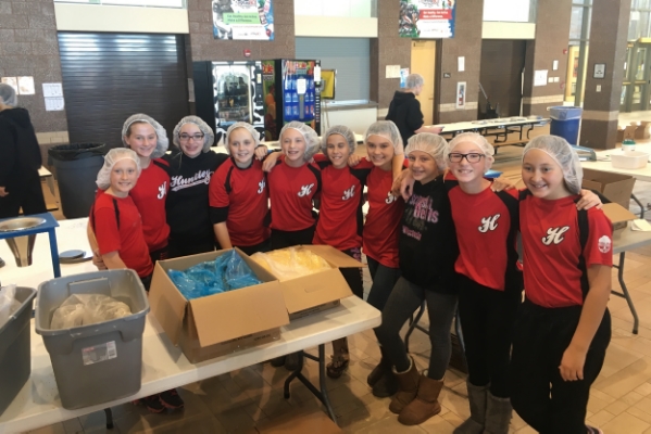 12U Red Team volunteering with Feed My Starving Children to pack meals being shipped all over the world.