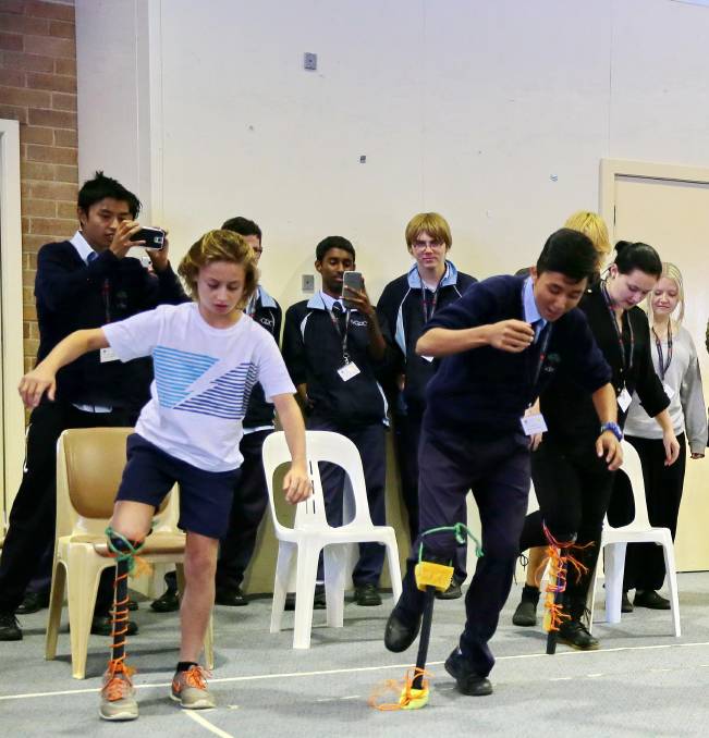 ENGINEERING: Luke Ellis from Hawker Area School (left) tests out the work of fellow who students who had to build a functioning bionic leg out of basic materials.